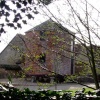 Old brick farm building on staddle stones in Gillingham, Dorset