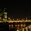 London Hammersmith Bridge at night from the towpath on the Barnes side of the River Thames.