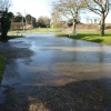 Water pouring along the road at Mettingham