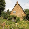 A traditional old cottage with its pretty cottage garden at Alkerton