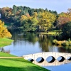 Autumn View of the 5 Arch Bridge & Gothic Temple at Painshill Park in Cobham, Surrey