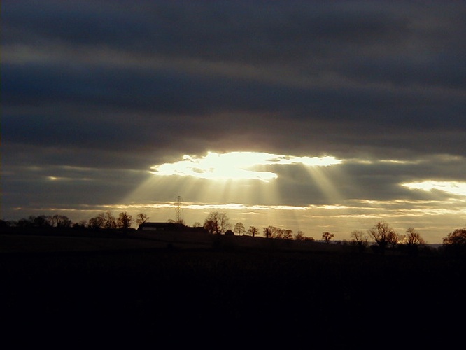 Photograph of sunburst over Nether Burrows, Derbyshire