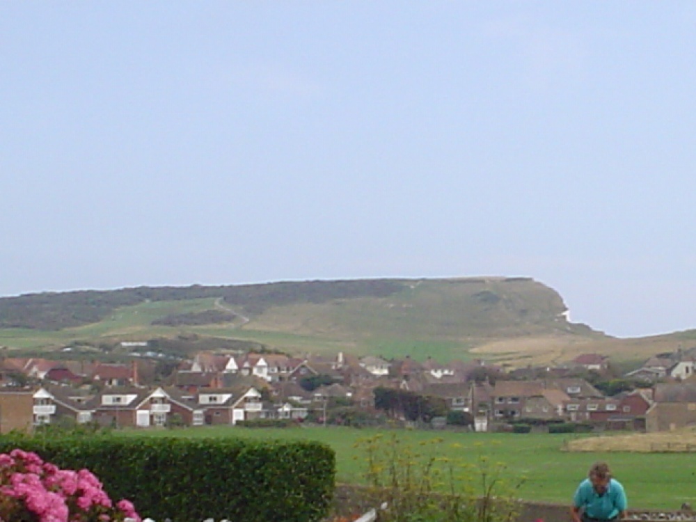 A picture taken walking along a road in Seaford. Beachy Head is in the background.
