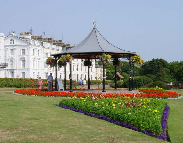A View of the bandstand with the Victorian buildings of the Crescent in the background
