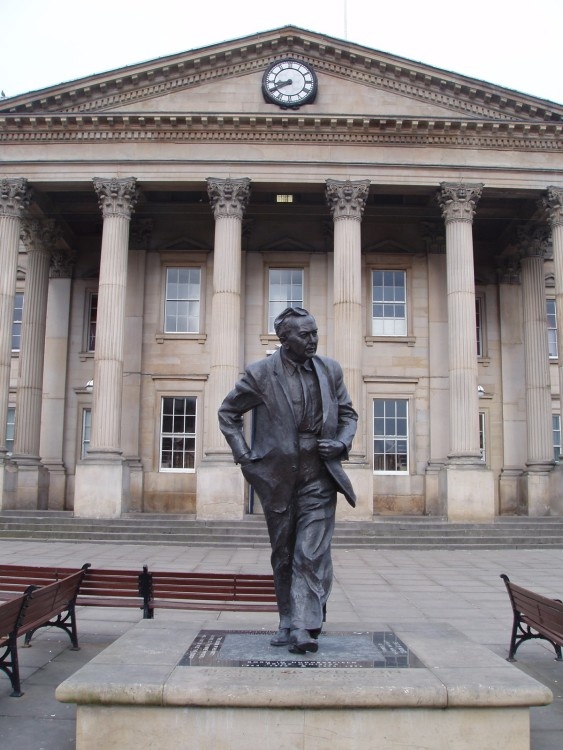 A statue in front of Huddersfield Railway station