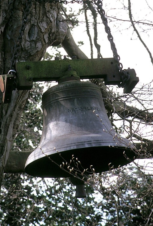 Guarlford Church bell hangs in a tree