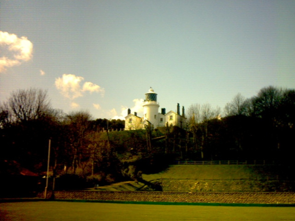 View of lowestoft lighthouse across sparrows nest bowling green photo by Mark Colvin