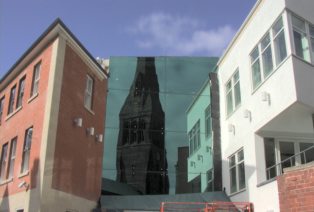 Leicester Cathedral reflected in a more modern building across the street photo by Greg Ward