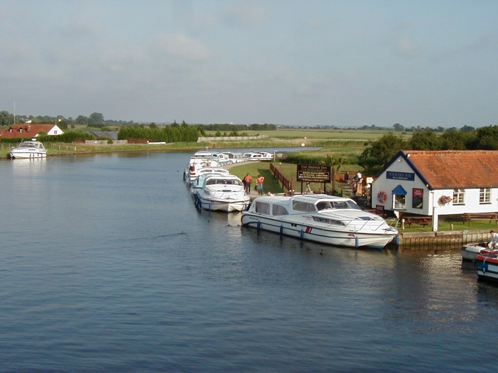 Photograph of The River Bure and The Bridge Inn at Acle, in the Norfolk Broads.