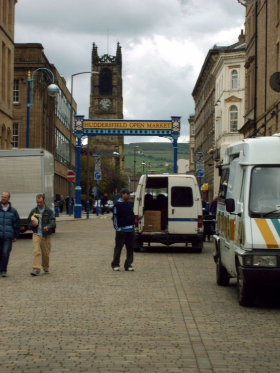 Market traders vehicles outside The Open Market, Huddersfield.