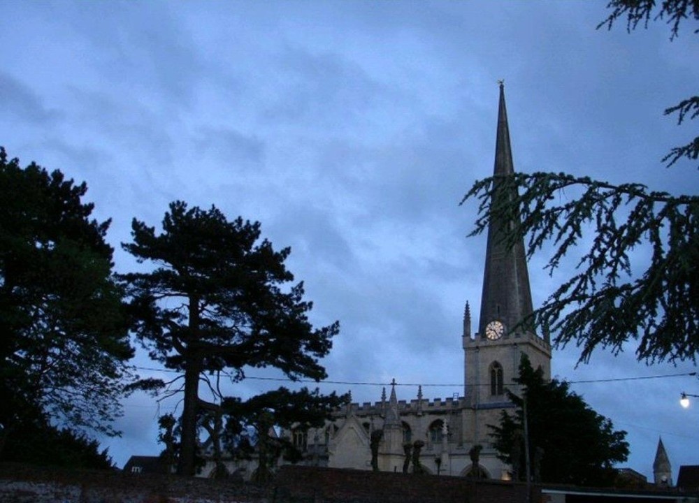 Photograph of St James' Parish Church at night with Cedar and Pine