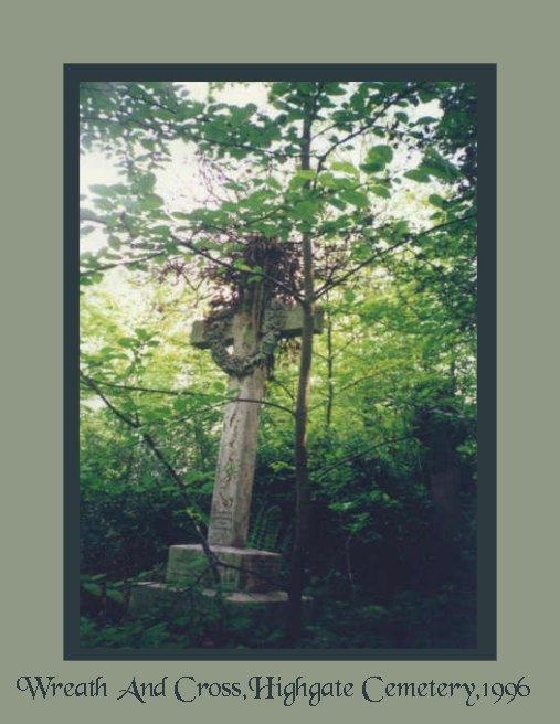 A wreath hangs on a cross in Highgate Cemetery in London