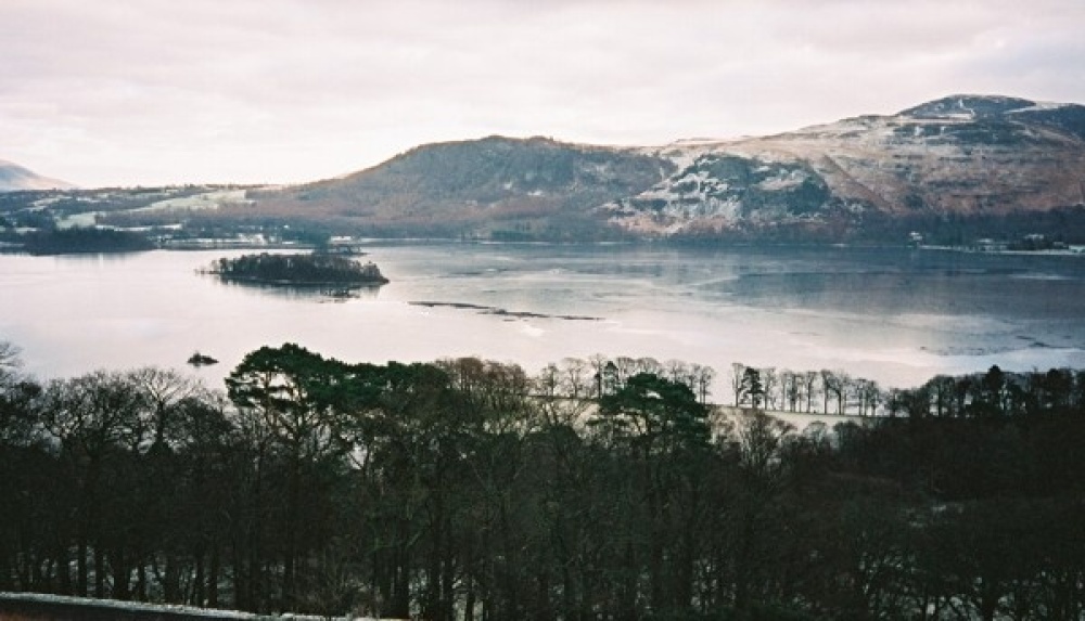 A frozen Derwent Water from the fell side path below Cat Bells Derwent , Cumbria