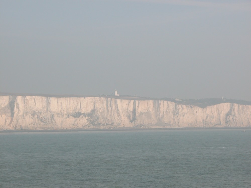 Misty View of the white cliffs of Dover with
the Lighthouse in the background