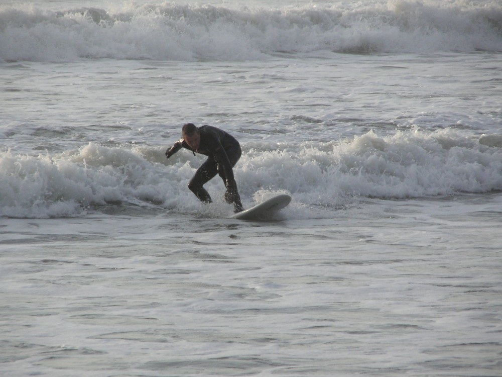 AUTUMN DAY WITH A LONE SURFER 2005 IN THE SEA AT TYWYN, WALES