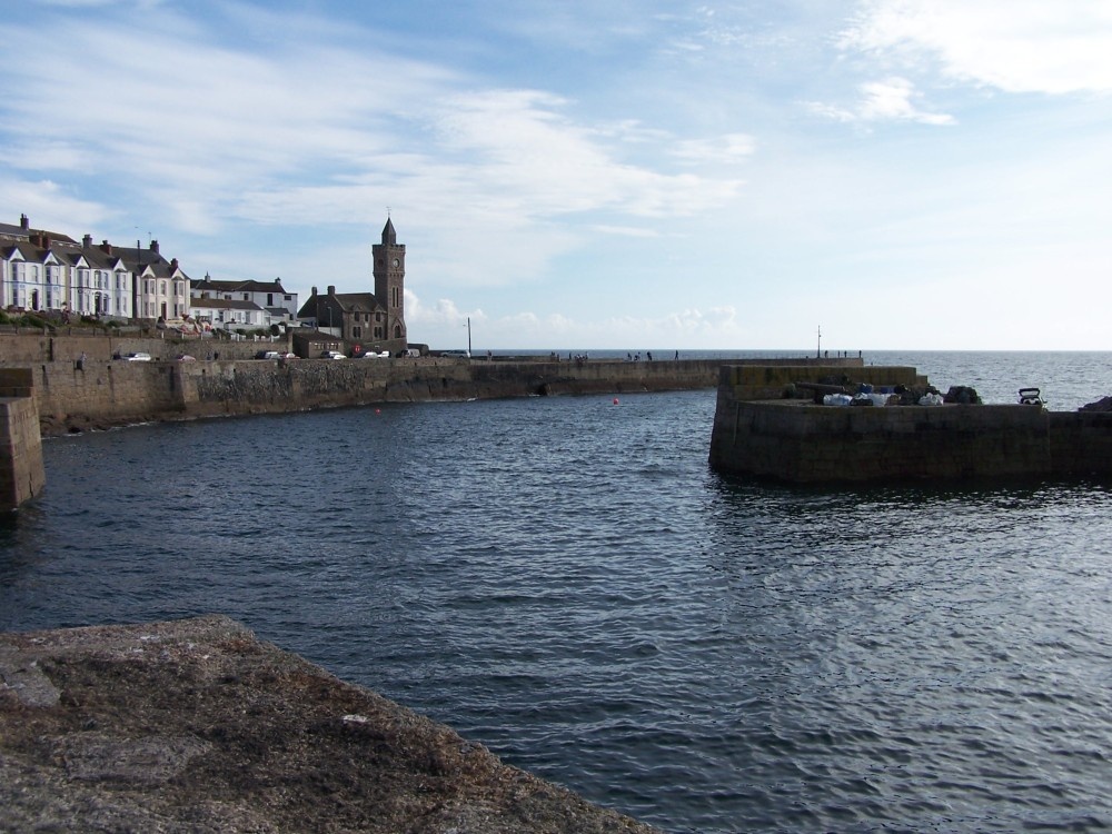 Porthleven, Cornwall. The harbour mouth, the clock tower is part of the old library.