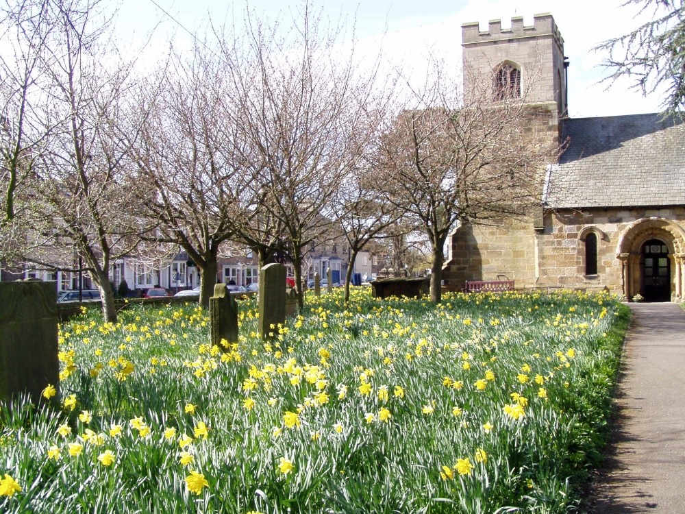 St. Oswalds Church, Sowerby, North Yorkshire with daffodils in full bloom.