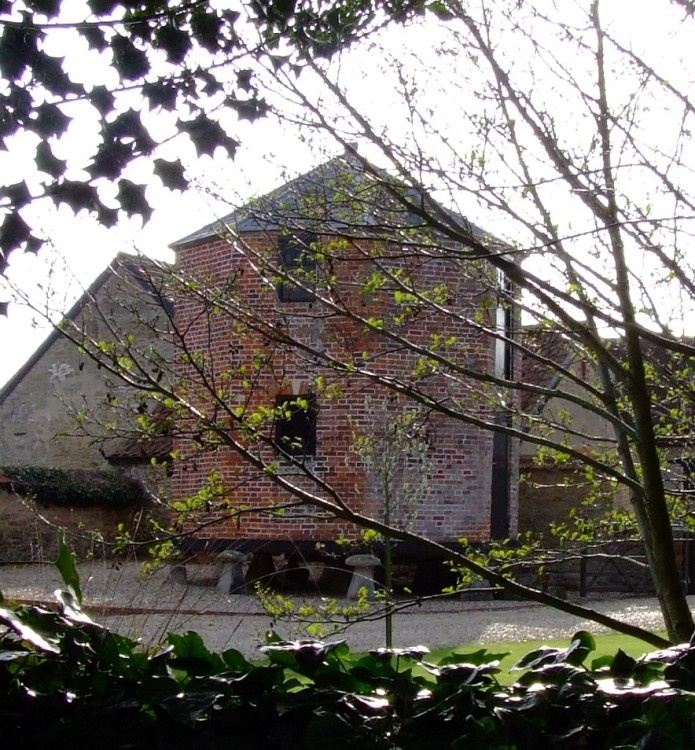 Old brick farm building on staddle stones in Gillingham, Dorset