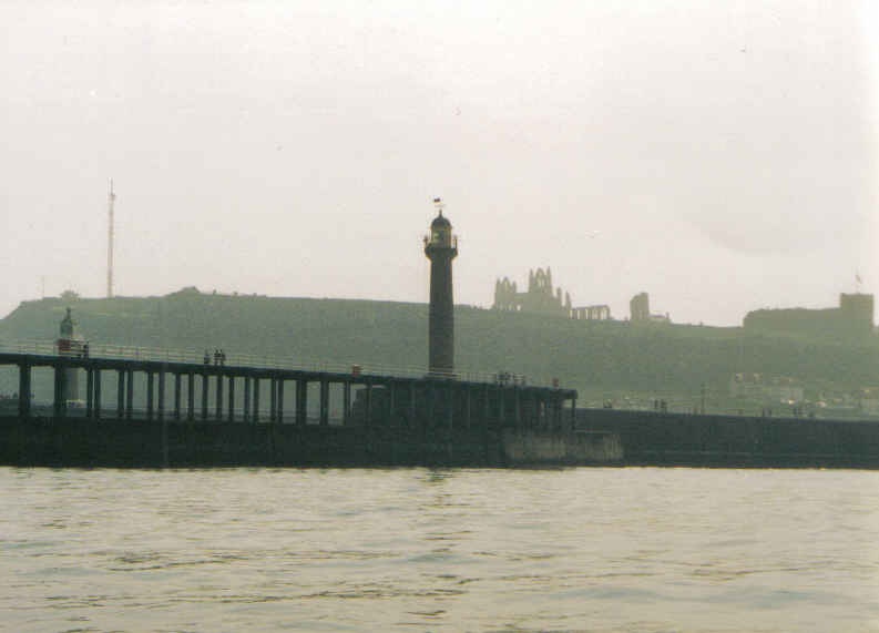 A view of Whitby Abbey taken from a boat entering the harbour