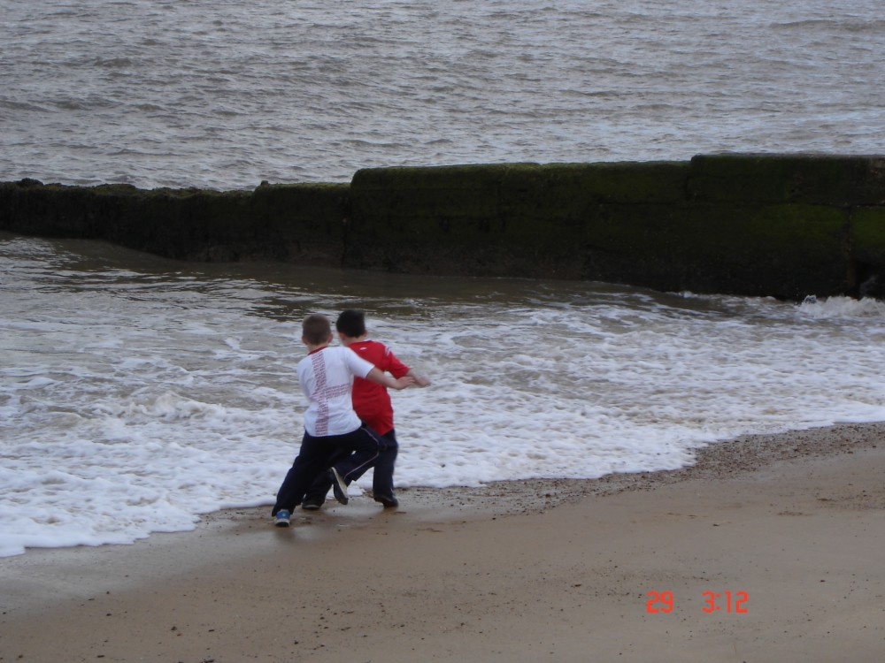Felixstowe, Suffolk. Kids playing with the waves..