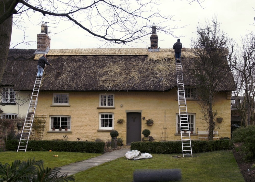Wrea Green, Lancashire. Thatchers at Work in Wrea Green Village Centre.