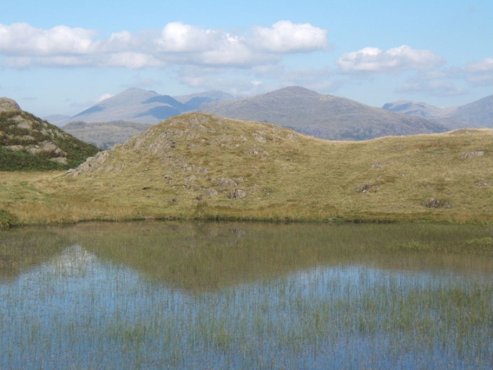 Photograph of Stickle Tarn set high up on Stickle Pike near Ulpha, Duddon valley.  Scafells in the background.