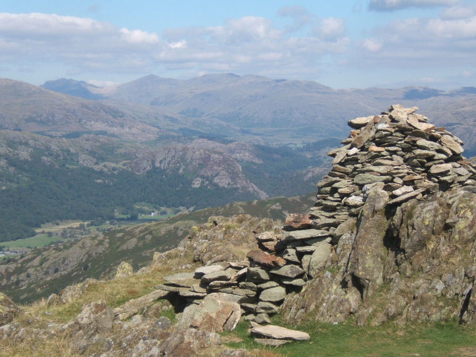 Photograph of Top of Stickle Pike near Ulpha, looking to Esk Pike, Bowfell and Crinkle Crags.