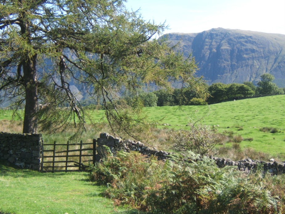 Photograph of Gentle farmland of lower Wasdale with the dramatic backdrop of the screes.
