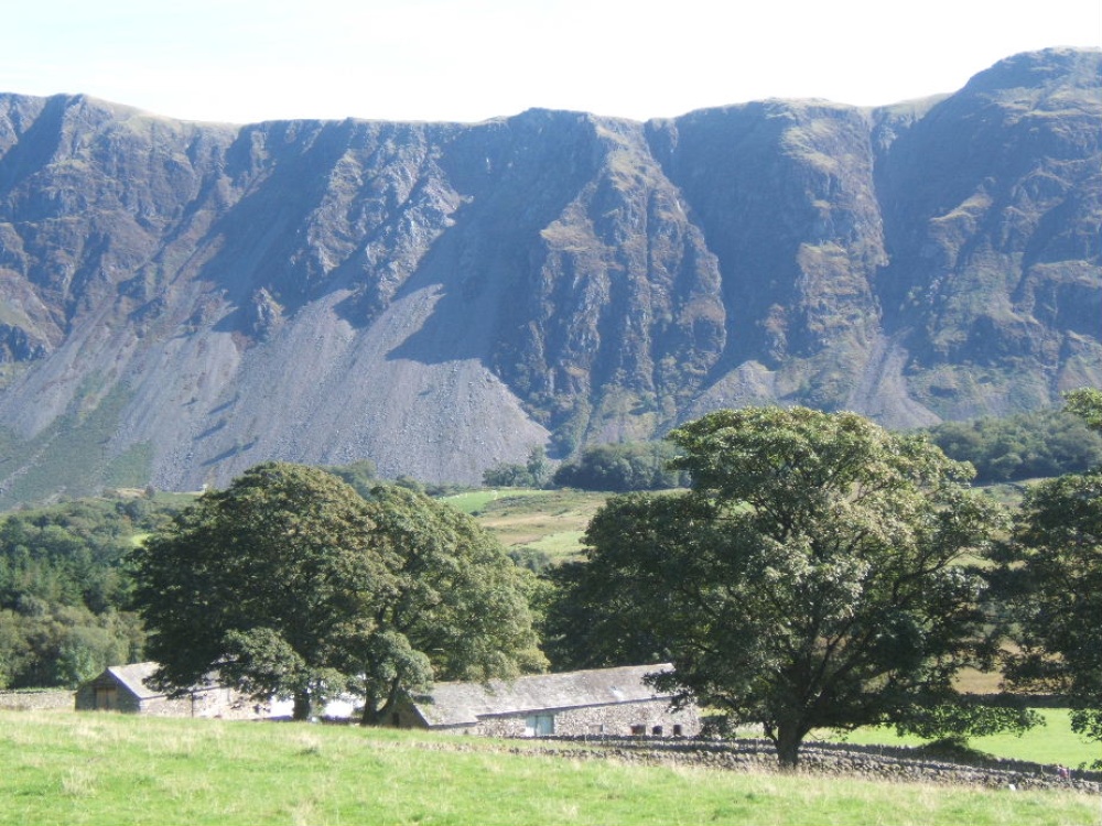 Photograph of Gentle farmland of lower Wasdale with the dramatic backdrop of the screes.