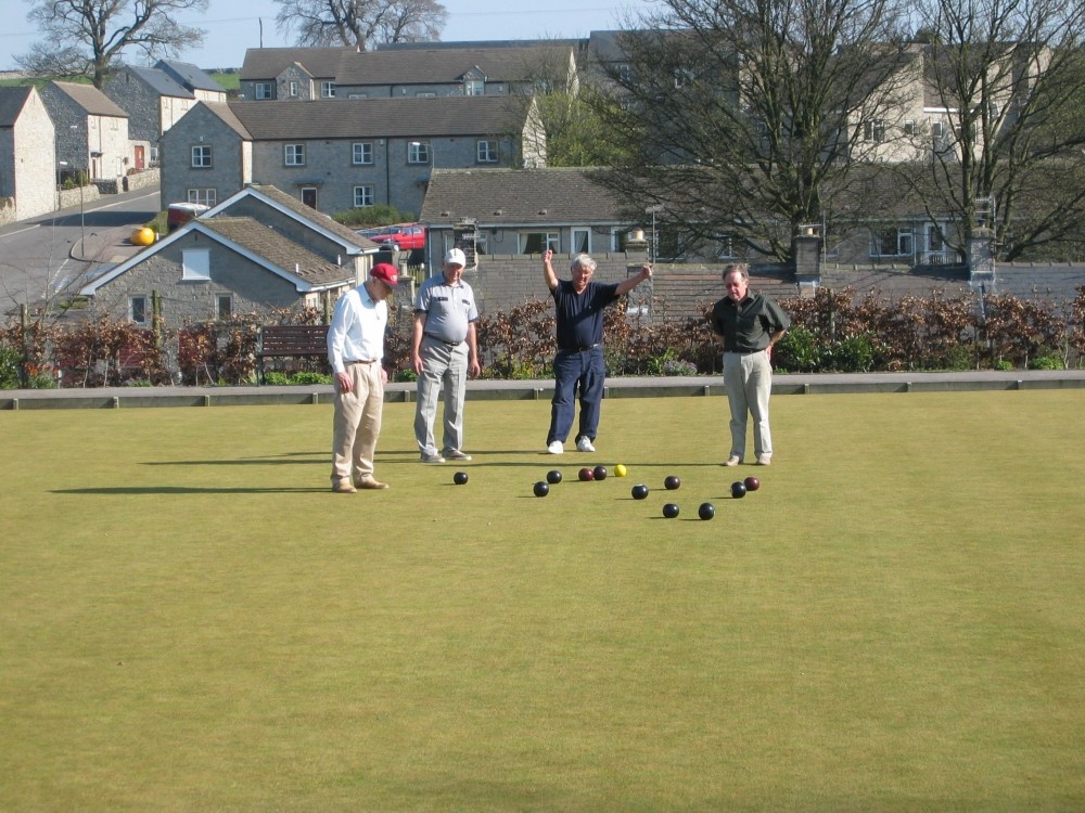 Photograph of Tideswell crown green bowling club overlooking tideswell welcomes vistors.