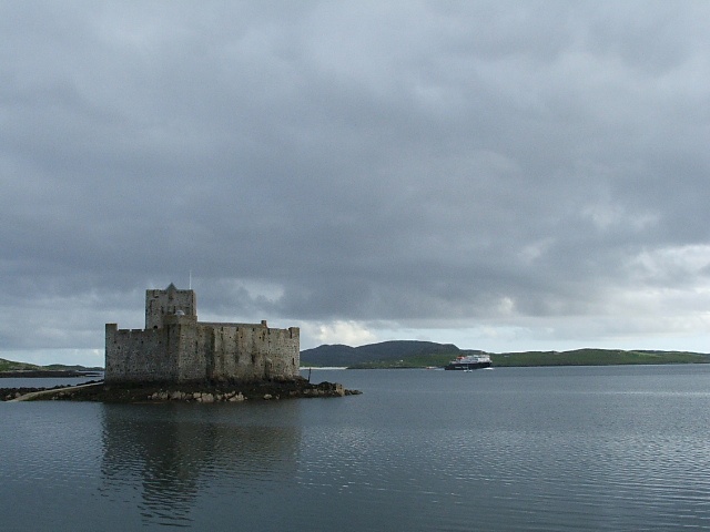 Photograph of Castle Kismul in Castlebay with incoming ferry in backround