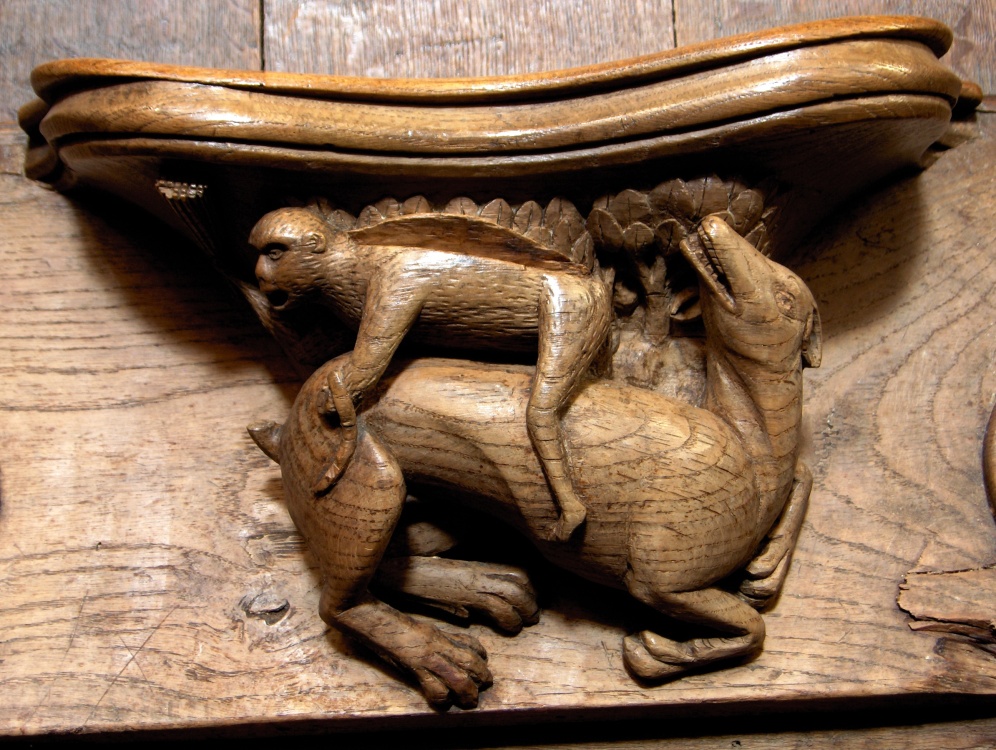 Norwich Cathedral misericord - Ape riding a dog. Norwich, Norfolk.