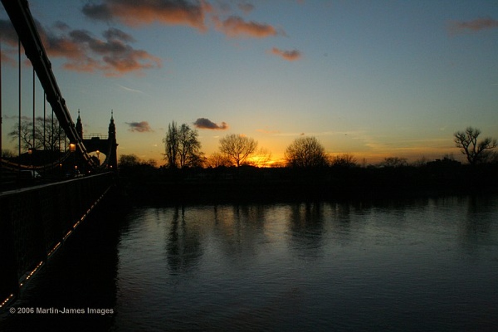 Photograph of London River Thames Hammersmith Bridge Sunset from the bridge.