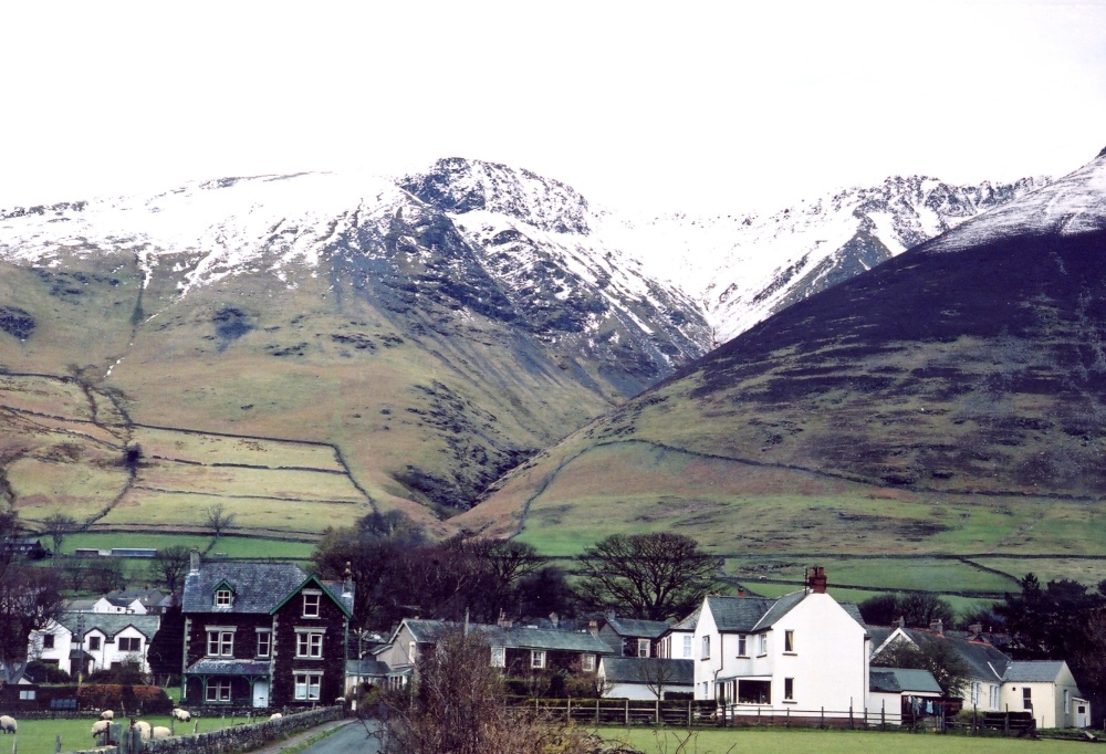 Photograph of Threlkeld Village, Cumbria. The Knowe crags in the background.