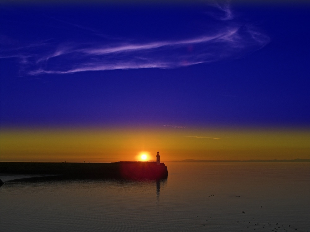 Photograph of Sun setting over west pier at Whitehaven, Cumbria