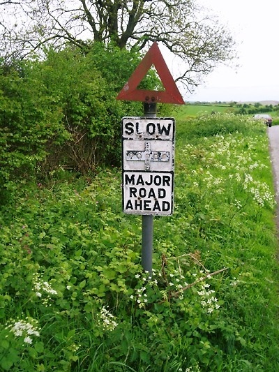 Ageing Slow sign at a crossroads on Clyro Hill in Radnorshire, Powys