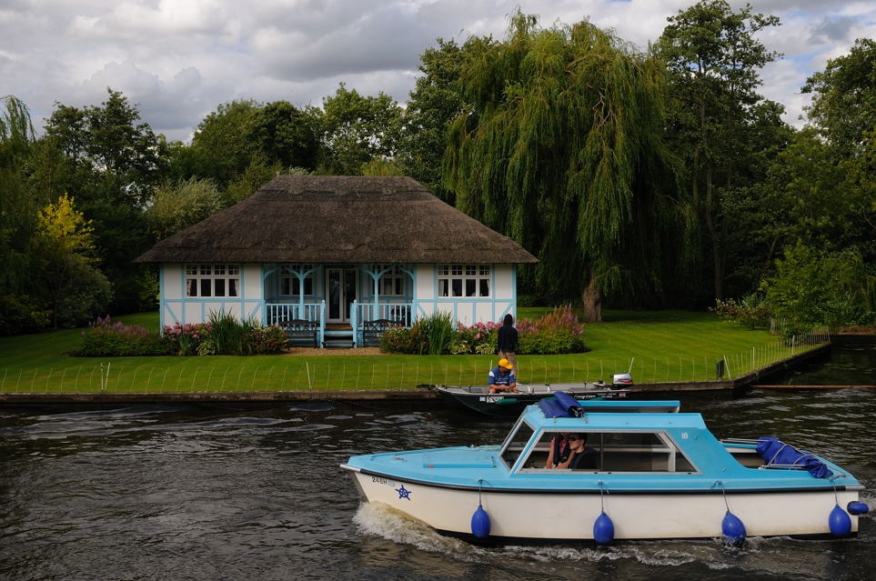 Photograph of Pleasure boat and house near the Broad