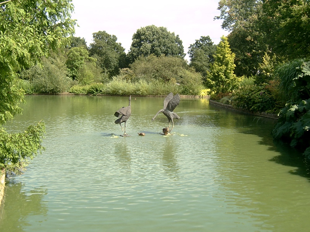 Statues of birds in a lake.