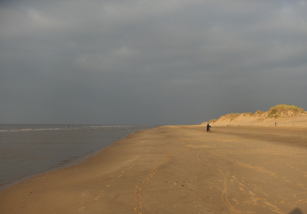 Photograph of A cyclist heads towards Southport - on foot.....