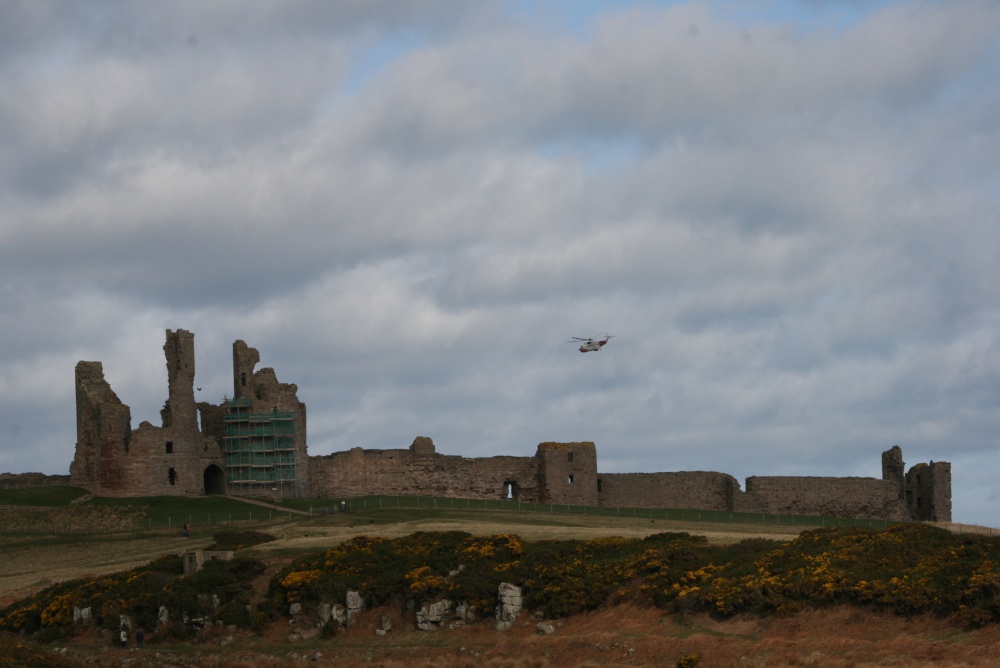 Dunstanburgh Castle with RNLI rescue helicopter
