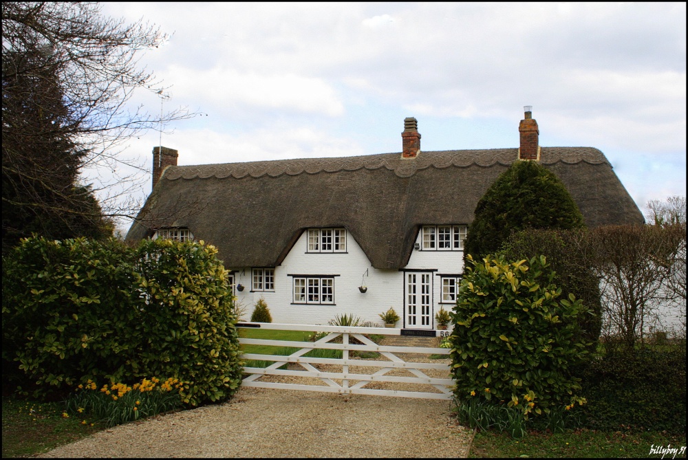 A white, thatched cottage