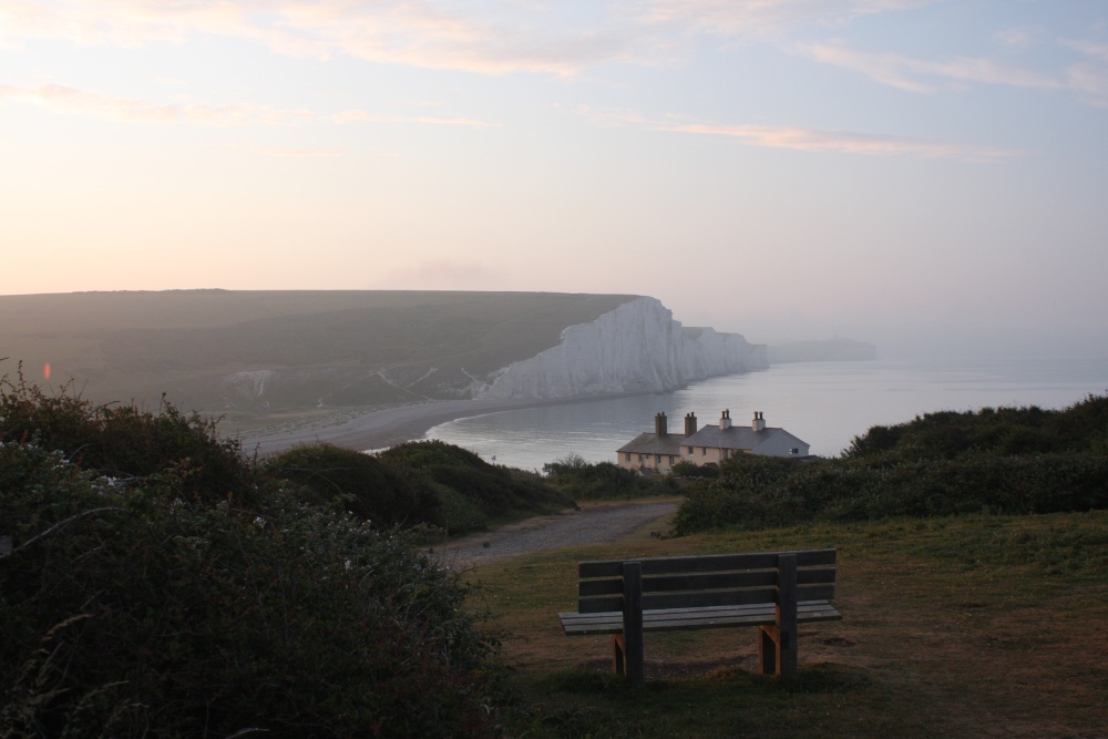 Sunrise over a bench in front of the coastguard houses