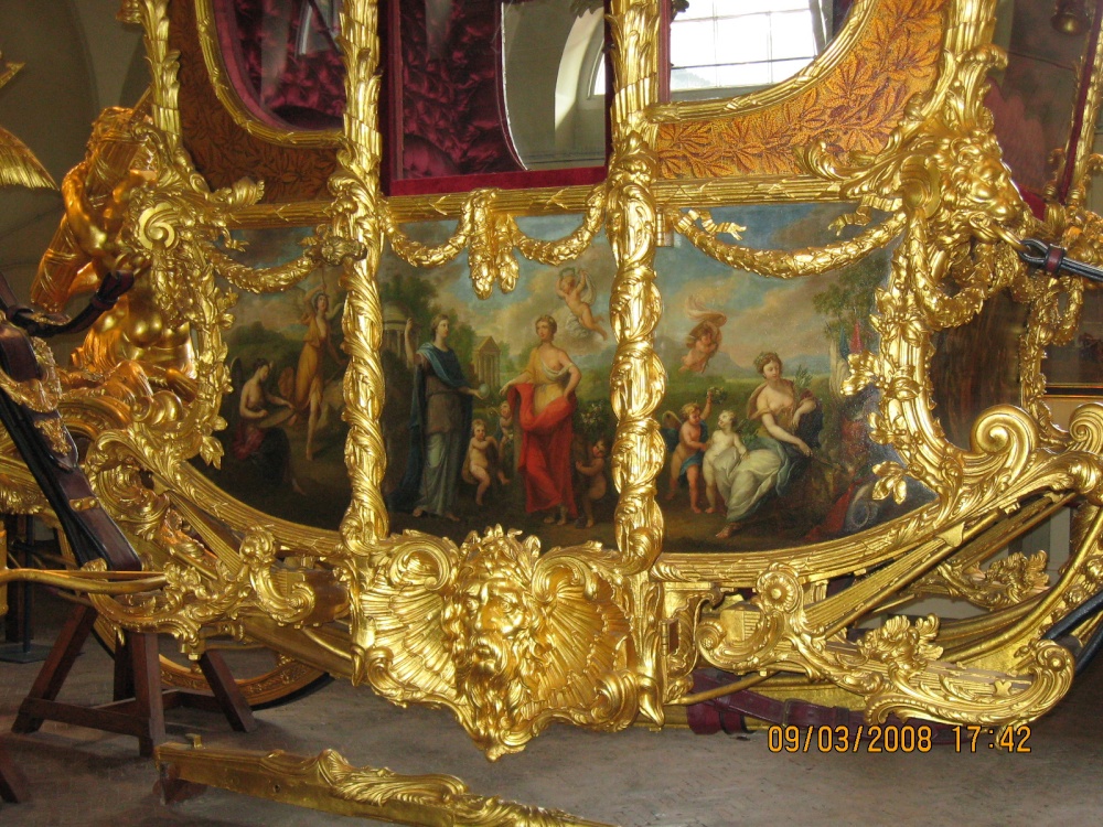Royal Mews.  A close-up of the artwork that adorns one side of the gilded coach. I assume the other side is the same.