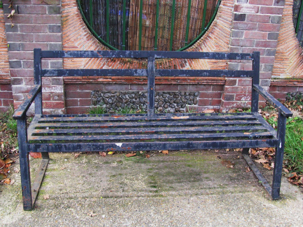 A hard looking seat outside the Almshouses