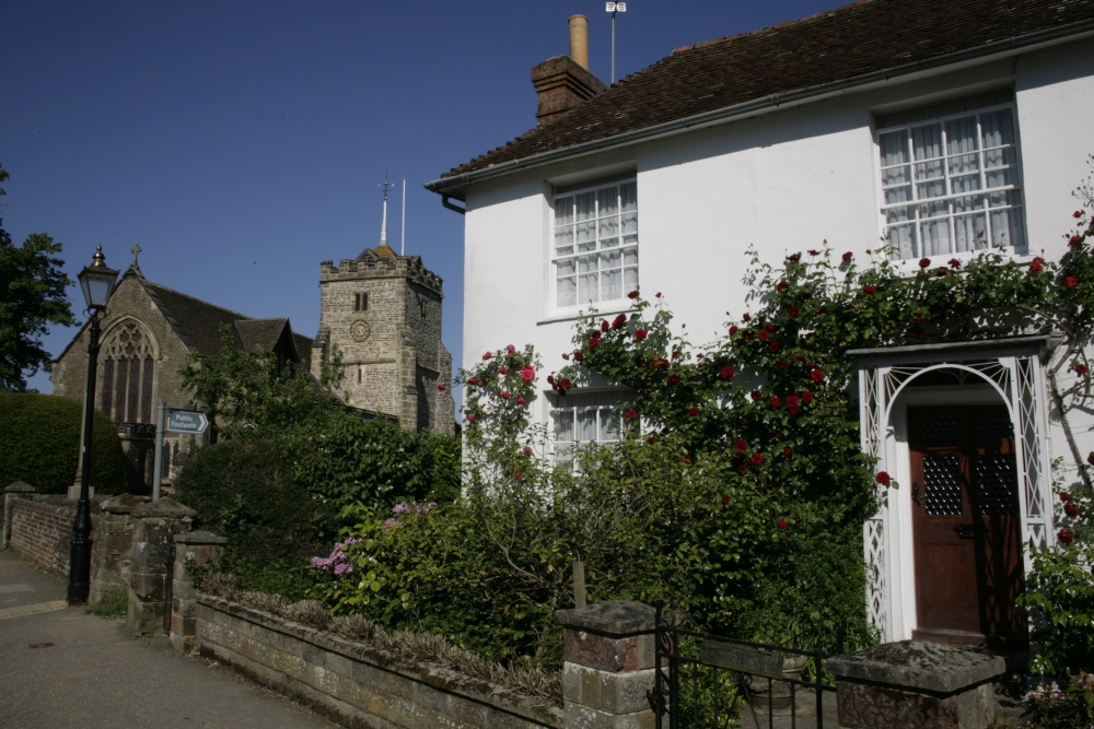Photograph of Cottage in village with  flowers and Church