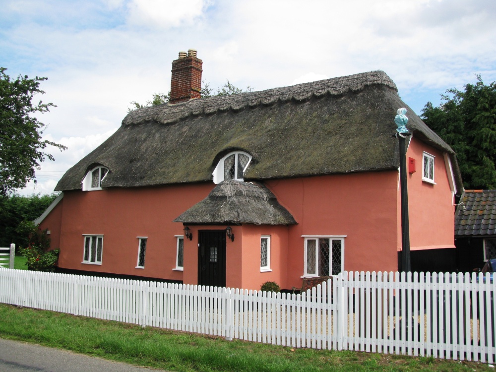 Photograph of Pink thatched house on outskirts of the village