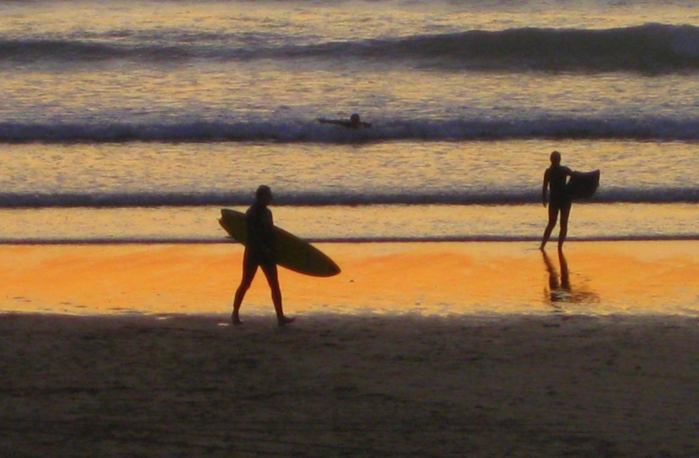Photograph of Sunset surfers