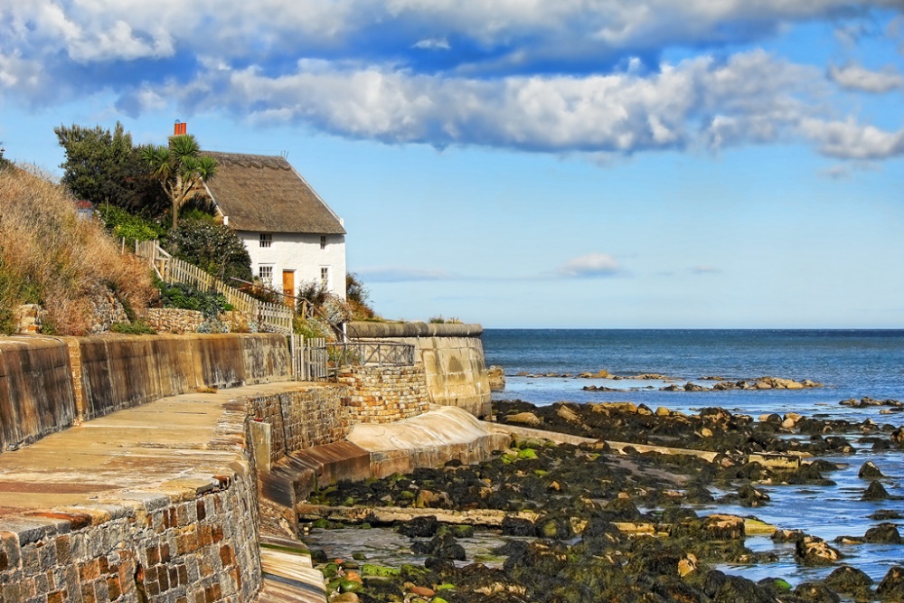 Photograph of Thatched cottage on the bay.