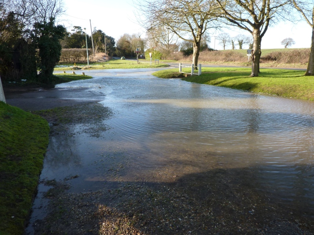 Photograph of Water pouring along the road at Mettingham