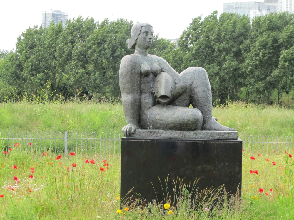 Photograph of Woman And Fish Statue